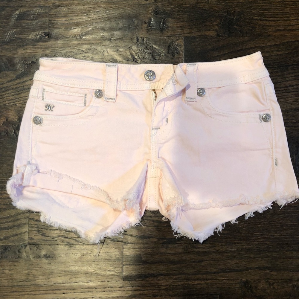 Pale Pink with rhinestones Miss Me cut off shorts.